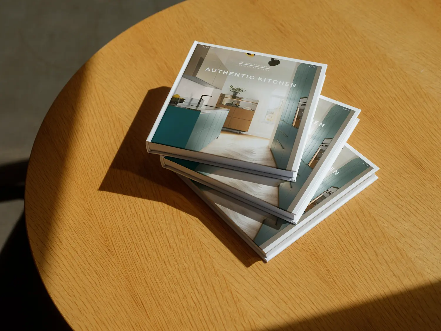 Mockuuups mockup of stacked hardcover books on a wooden table